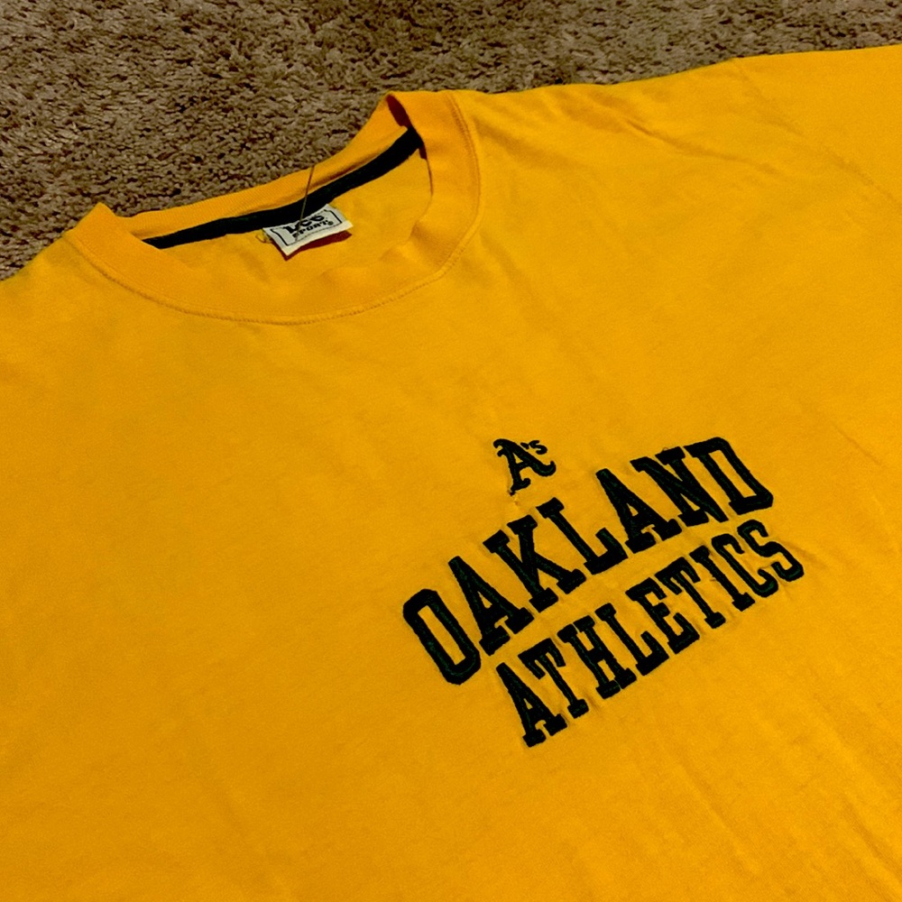 Vintage Lee sports Oakland A’s embroidered mustard tee.